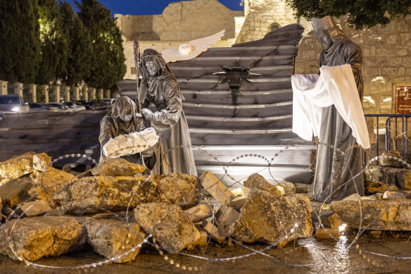 An artwork called Nativity Under the Rubble by Palestinian artist Tariq Salsa is photographed in Manger Square near the Church of Nativity in Bethlehem in the West Bank. In the place of baby Jesus, the artwork shows a child surrounded by rubble.