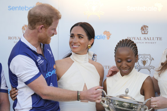 Meghan, with husband Prince Harry, at a charity polo match event.