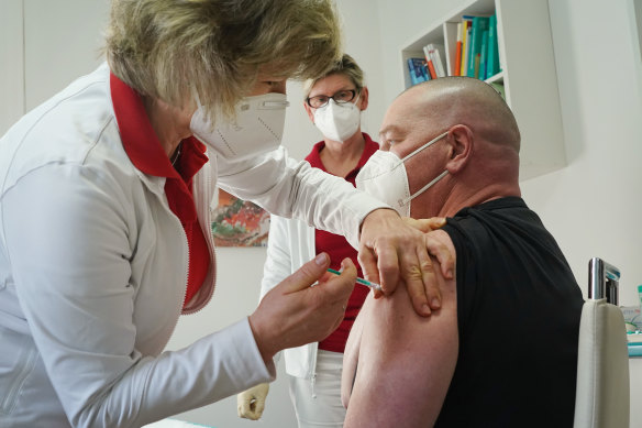 Doctor Claudia Richartz inoculates a healthcare worker against COVID-19 with the AstraZeneca vaccine in Germany,