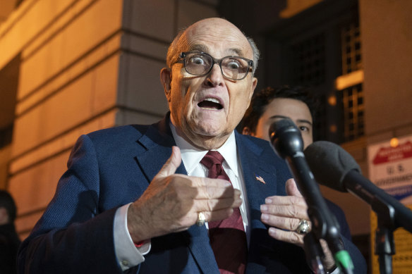 Former New York mayor Rudy Giuliani talks to reporters outside court in Washington. The trial will determine how much he pays in damage to two defamed Georgia election workers.