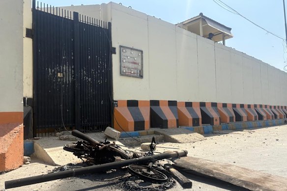 A motorcycle set on fire by protesters is seen outside the US consulate in Karachi. 
