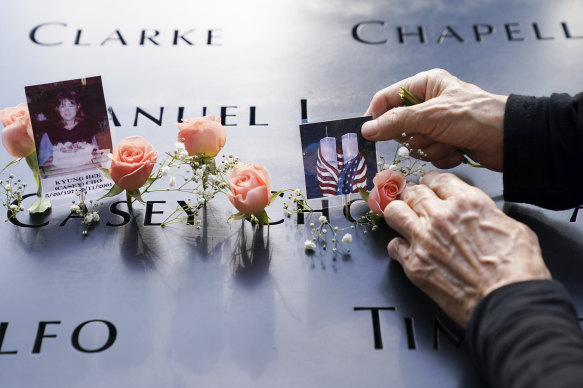 Mourners place flowers and pictures on the September 11 memorial in New York City.