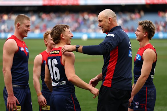 Bailey Laurie celebrates the Demons’ win with coach Steven King.