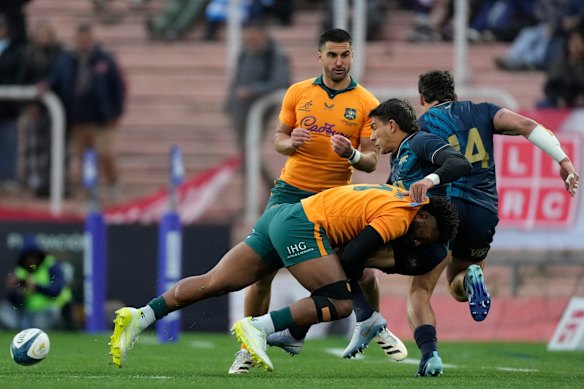 Argentina’s Santiago Carreras, right, is tackled by Australia’s Filipo Daugunu