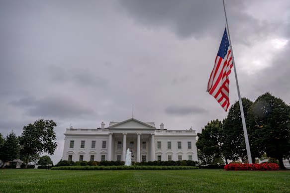The American flag on the North Lawn at the White House flies at half mast after the shooting.