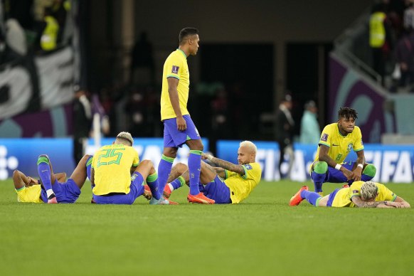 Brazil’s Neymar, center, and his team mates react after the penalty shootout.