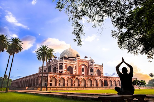 A man practises yoga on the lawns of Delhi’s Humayun’s Tomb during the quiet early morning.