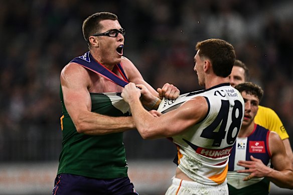 Mason Cox of the Dockers wrestles with Mark Keane of the Crows.
