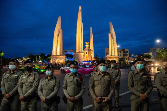 Police monitor an anti-government protest in Bangkok on Monday.