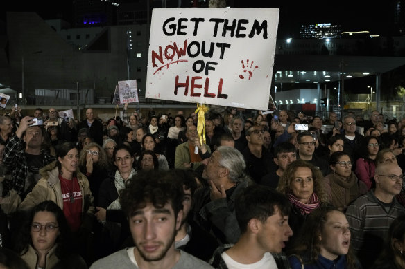 A man holds a sign calling for the release of the hostages taken by Hamas militants at a Tel Aviv protest this weekend.
