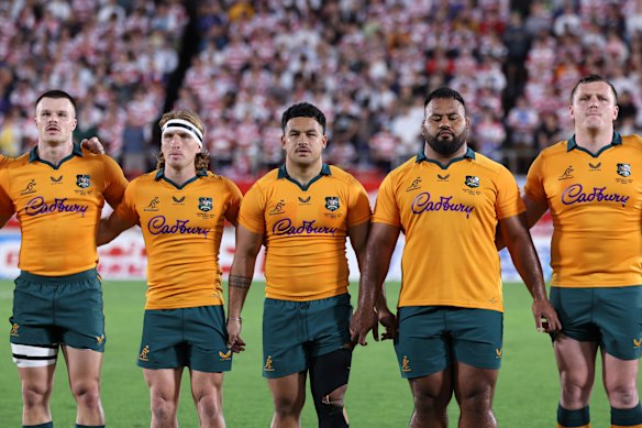Isaac Henry, Tate McDermott, Hunter Paisami, Taniela Tupou and Angus Bell await the national anthem.