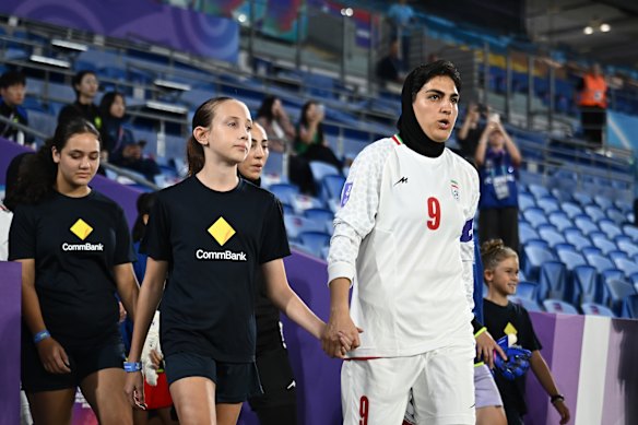 Captain Zahra Ghanbari leads Iran out for their Asian Cup match against South Korea on March 2.