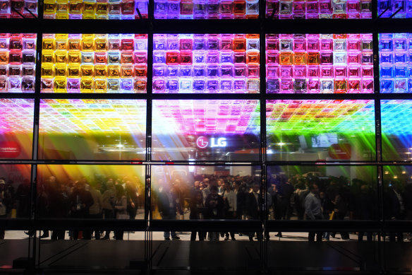 People look at an exhibit of LG Signature OLED T 4K transparent wireless TV’s at the LG booth during the CES tech show Tuesday, Jan. 9, 2024, in Las Vegas. (AP Photo/John Locher)