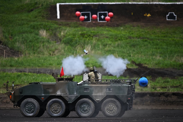A soldier fires an anti-tank missile from a light-armoured vehicle during the Japan Ground Self-Defence Forces' annual live fire exercise in May.