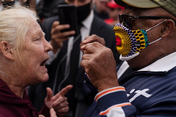 A Trump supporter, on the left, argues with a counter-protester outside Detroit's TCF centre, where votes were being counted. 