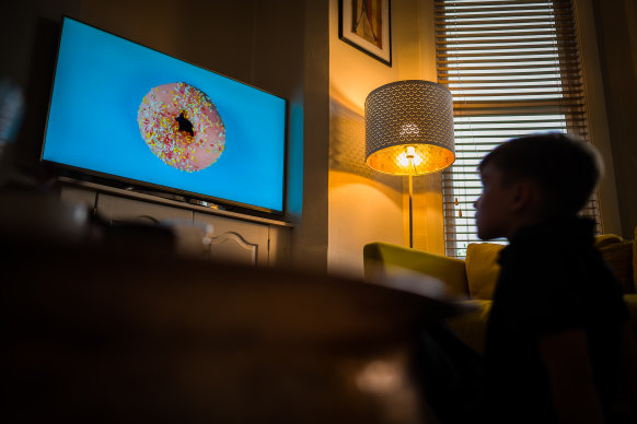 A child watches a new NHS ad on television that aims to promote healthy eating and exercise in lieu of junk food.