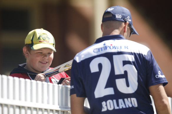 Scott Boland signs an autograph at Junction Oval during Victoria’s opening game.