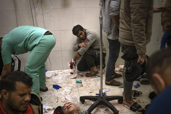 A man waits to be taken care of after being wounded in an Israeli army bombardment of the Gaza Strip, in the hospital Khan Younis.