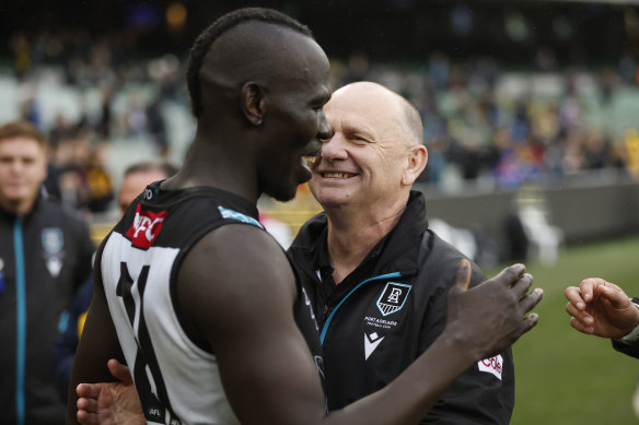 Power defender Aliir Aliir celebrates victory with coach Ken Hinkley.