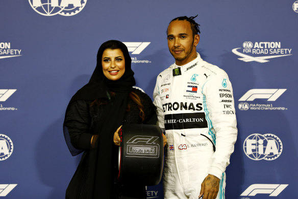 Aseel Al-Hamad presents Lewis Hamilton  with the Pirelli Pole Position trophy. 