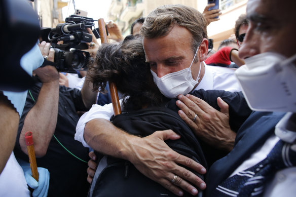 French President Emmanuel Macron hugs a resident during a visit to Beirut on Thursday.