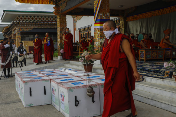Monks perform a ritual as 500,000 doses of Moderna COVID-19 vaccine gifted from the United States arrived at Paro International Airport in Bhutan on July 12.