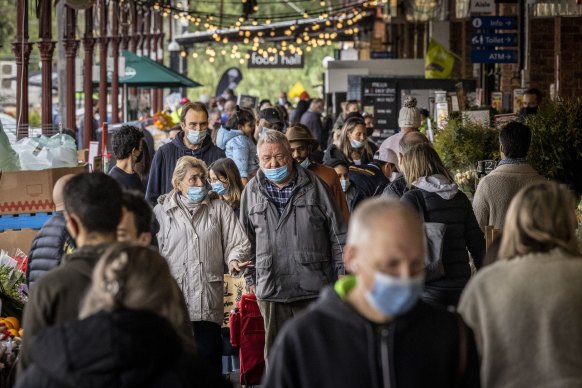 Shoppers with masks at South Melbourne Market - which has since been named as an exposure site - yesterday as Melbourne’s COVID-19 restrictions continued. 
