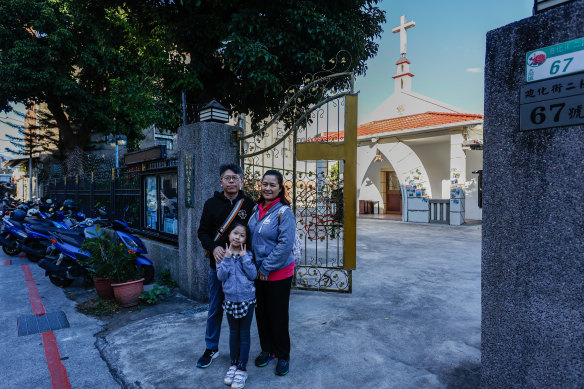 Alex Chan with his wife and his daughter outside a polling station in Taipei. 