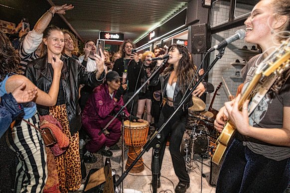 Local band the Seeding plays to crowds in the centre of Byron Bay, after the Splendour in the Grass music festival was cancelled due to bad weather in 2022.