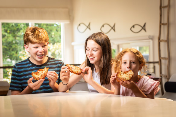 Charlie, 14, Sophie, 12, and Lucy, 6, eating a new McCain vegemite pizza.