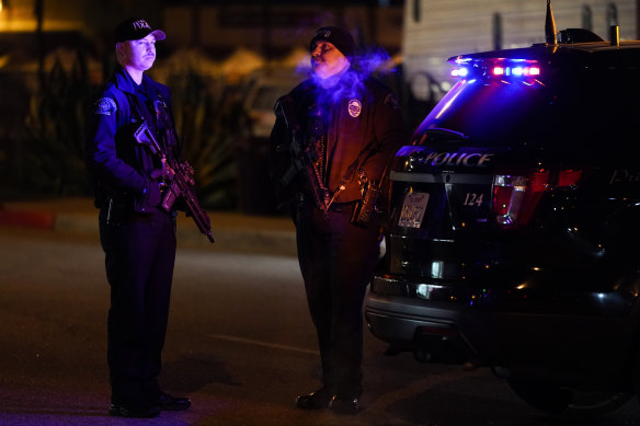 Police stand guard near the ballroom shooting in Monterey, California, in the early hours of Sunday.