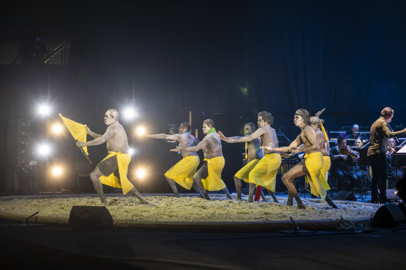 The Bungul dancers perform in a sand-covered circle at the front of the stage in a uniquely Australian amalgamation.