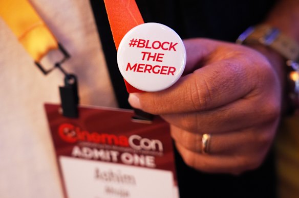 An attendee at CinemaCon in Las Vegas on April 14 sports a pin opposing the Paramount-Warner Bros. Discovery merger.