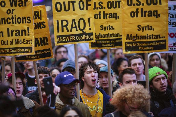 Protesters march in Times Square to oppose US action against Iran.