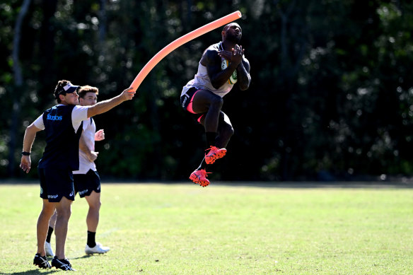 Suliasi Vunivalu leaping high for a catch at Wallabies training.
