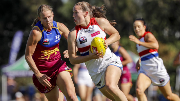 Hot pursuit: Western Bulldogs forward Isabel Huntington evades a tackle by Kate Lutkins of the Lions.