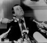 Firmly back in the chair... Premier Neville Wran at a press conference to announce the findings of the Royal Commission on July 28, 1983.