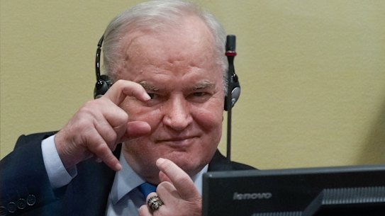 Former Bosnian Serb military chief Ratko Mladic mimics photographers taking pictures as he waits to hear the result of his appeal on Tuesday.
