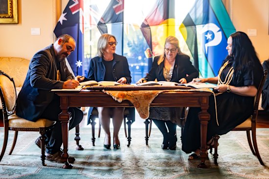 From right to left: First Peoples’ Assembly co-chair Rueben Berg, Premier Jacinta Allan, Minister for Treaty Natalie Hutchinson and assembly co-chair Ngarra Murray sign Victoria’s statewide treaty at Government House.