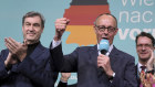 Friedrich Merz, front right, leader of the Christian Democratic Union (CDU), gestures while addressing supporters at the party headquarters in Berlin. 