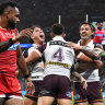 The Broncos celebrate Gehamat Shibasaki’s try against the Dolphins.