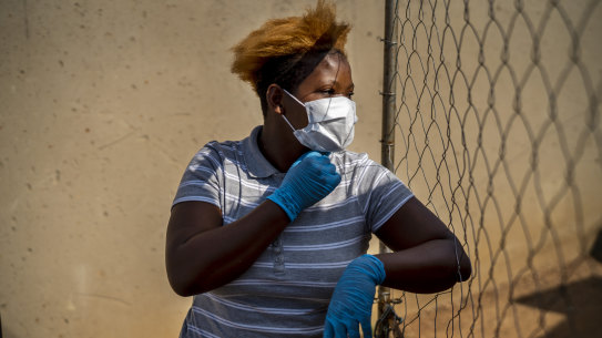 Mabatho Mphuthi is one of the very few people wearing a mask in response to the COVID-19 virus outbreak in the Diepsloot township north of Johannesburg, South Africa, on Saturday.