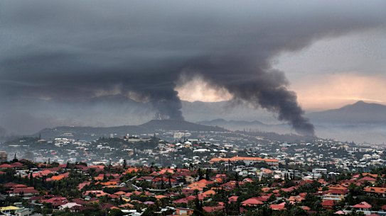 Smoke rises during protests in Noumea, New Caledonia.