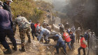 Rescue workers recover the body of a victim of the passenger plane that crashed in Pokhara, Nepal, on Sunday.