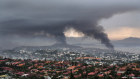 Smoke rises during protests in Noumea, New Caledonia.