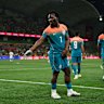 Nestory Irankunda of Australia throws on a silver glove and performs a Michael Jackson dance after scoring on Tuesday night.