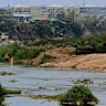 KK Park in Myanmar, known for its scam compounds, is seen across the Moei River on the Myanmar–Thailand border.