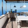 Beyond the fragrant garden is a terrace offering panoramic views. The
large table, by Santa & Cole, is designed to resemble an open kitchen.