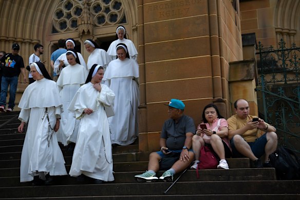 Along the route, people watch the procession.