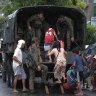 Residents in south-east Manila evacuate in a military truck before the typhoon hits.